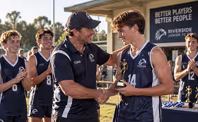 Coach recognising a player for improvement and team contribution