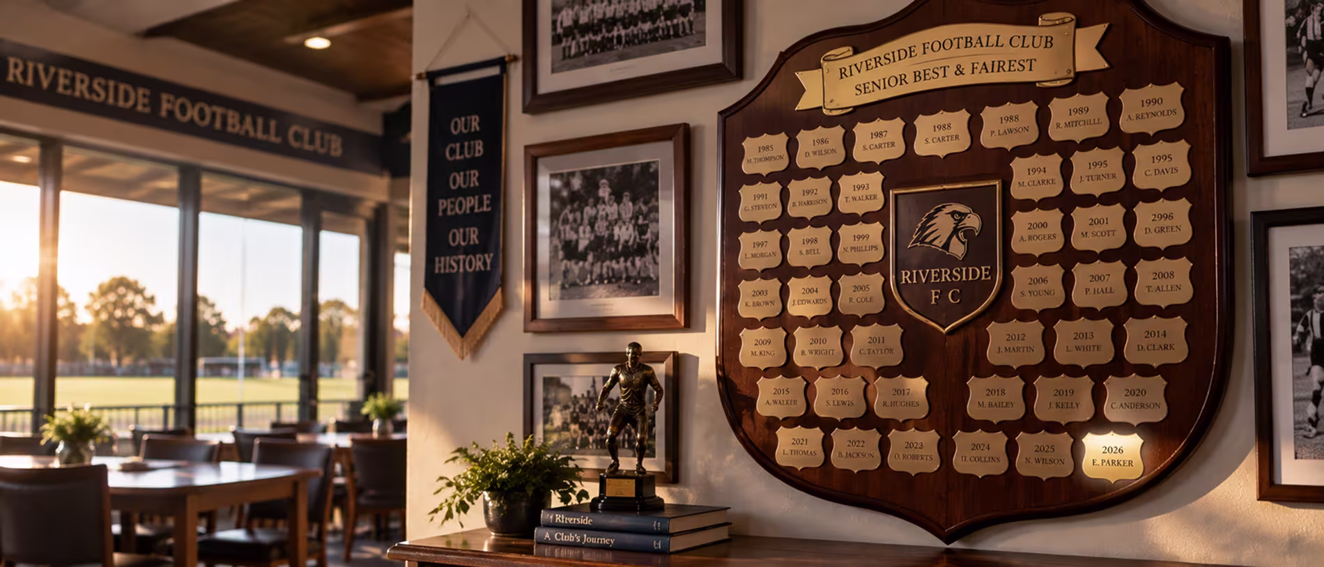 Timber perpetual football club honour shield with engraved winner plates displayed in an Australian clubroom